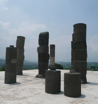 Atlantean Figures at Tula standing on a weathered platform beneath a partly cloudy sky.