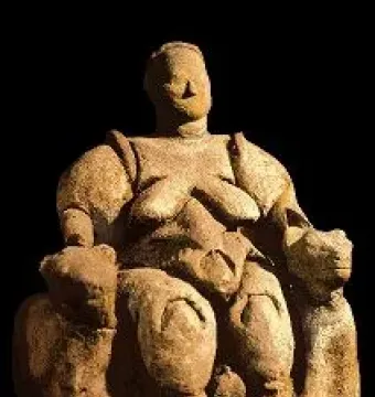 Seated Woman of Çatalhöyük figurine with rounded forms and animal-headed armrests.