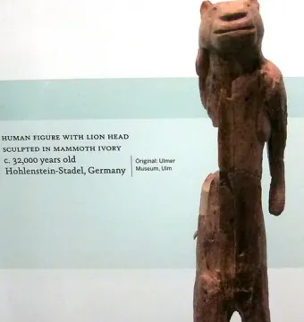 Lion-man sculpture with a lion-like head and human body standing upright.