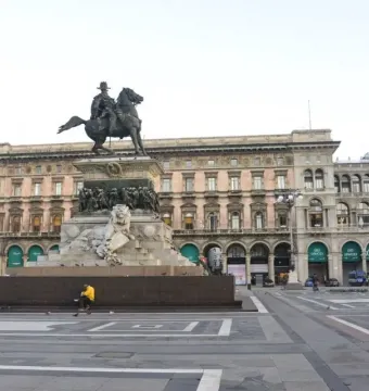 Victor Emmanuel II Monument with a bronze equestrian statue on a carved marble pedestal in a paved square.