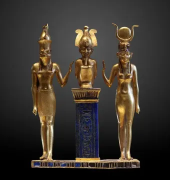 Osorkon II Triad showing three golden figures on a blue hieroglyphic pillar.