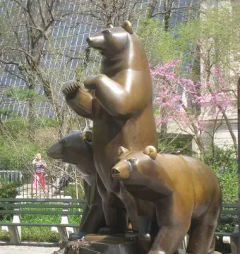 Group of Bears sculpture in Central Park, showing a bronze bear standing upright with two bears below it.