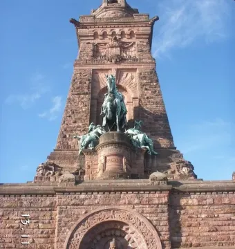 Kyffhäuser Monument with a large equestrian statue above a carved stone arch and seated bearded figure.