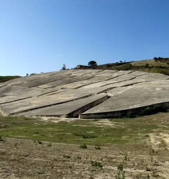 Il Grande Cretto with pale grey concrete slabs broken by deep angular fissures on a hillside