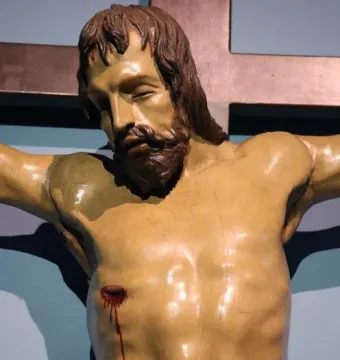 Santa Croce Crucifix showing a close-up of Christ on the cross, with his head bowed and a wound on his right side.