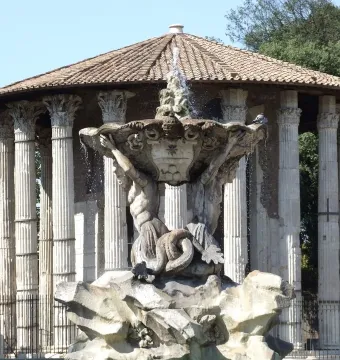 Fountain of the Tritons with a shell-like basin supported by two muscular figures, in front of an ancient circular temple in Rome.