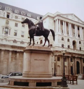 The Duke of Wellington equestrian monument on a stone pedestal in front of a classical building.