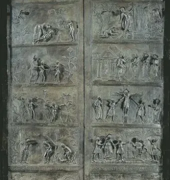 Bernward Doors with tall bronze relief panels showing multiple narrative scenes and lion-head knockers.