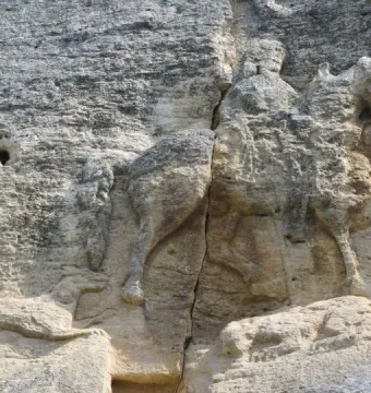 The Madara Rider rock relief carved into a cliff face, showing a mounted figure above a lion and a smaller animal.