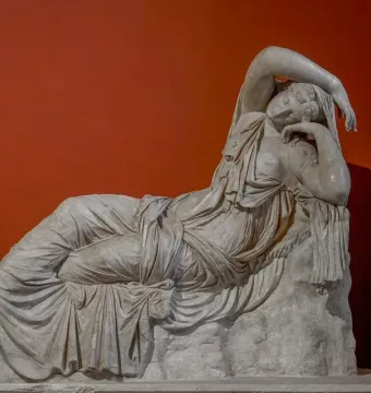 Sleeping Ariadne, a white marble sculpture of a reclining woman with her head resting on her arm.