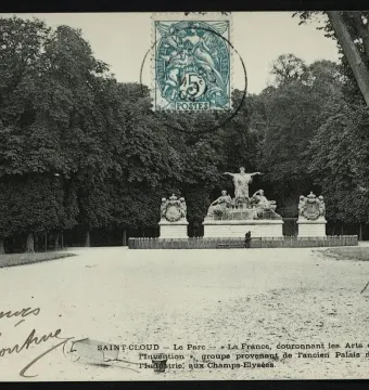 Black-and-white postcard of France crowning the Arts and Invention monument on a stone platform in a wooded park.