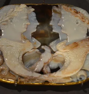 Gemma Claudia cameo with two facing profile portraits in wreaths, faint figures behind them, and an eagle between two cornucopias.