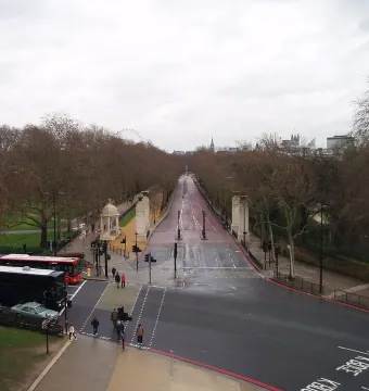 Commonwealth Memorial Gates beside a tree-lined avenue at Hyde Park Corner, London.