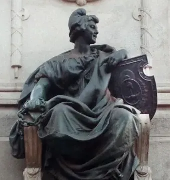 Bronze seated female figure on the Monument to Giuseppe Garibaldi, holding a broken chain and a decorated shield.