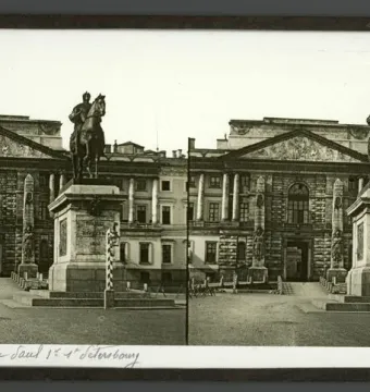 The Monument to Peter I stands on a stone pedestal in an open square with a classical building behind it.
