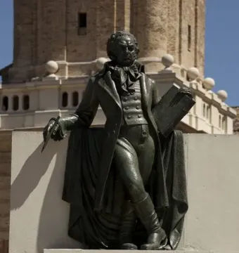 Goya memorial bronze sculpture of a man holding a paintbrush and sketchpad on a stone pedestal