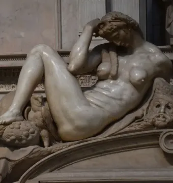 Michelangelo’s Night, a reclining marble female figure with an owl beneath her foot and a mask beside her arm.
