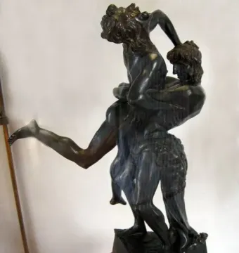Bronze sculpture of Hercules and Antaeus showing one figure lifting the other high into the air.