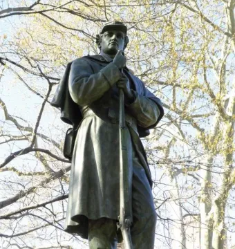 Seventh Regiment Memorial showing a uniformed soldier holding a rifle upright.