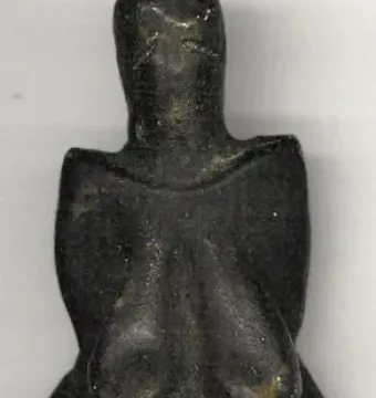 Venus of Dolní Věstonice figurine with rounded head, prominent breasts, and a full abdomen.