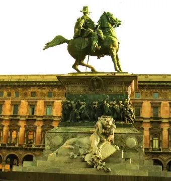Victor Emmanuel II Monument with a bronze equestrian statue on a grand sculpted pedestal and a white marble lion at the base.