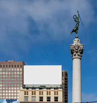 The Dewey Monument rises above Union Square, topped by a bronze figure holding a staff and wreath.