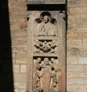 Tomb of Bruno the Priest stone relief with carved figures and vertical inscriptions