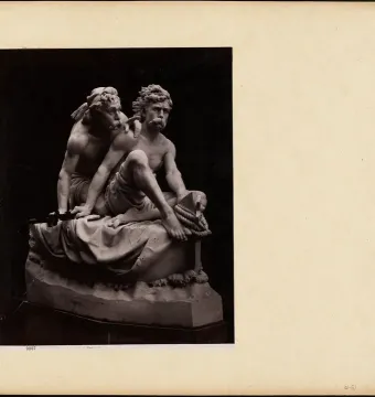 Kanaris at Chios marble sculpture showing two muscular, bare-chested men, one seated with a coiled rope and nautical tool while the other leans over his shoulder