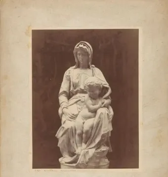 Michelangelo’s Madonna of Bruges sculpture showing the Virgin Mary seated with the Christ Child on her lap.