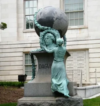 Daguerre Memorial granite monument with a bronze bust framed by a wreath, a draped female figure, and a globe on top