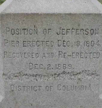 Close-up of the Jefferson Pier granite marker with carved capital-letter inscriptions.