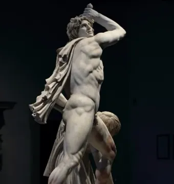 Ludovisi Gaul sculpture with a muscular warrior raising a sword over his head beside a fallen figure.