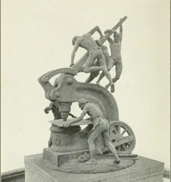 Mechanics Monument showing several laborers operating a large industrial machine on a pedestal.