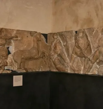 Bassae Frieze marble relief panels showing draped figures, a deer-like animal, and a centaur in a battle scene.
