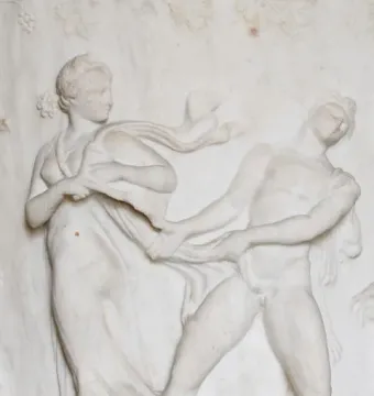 White marble relief on the Borghese Vase showing a draped woman and a nude man pulling at flowing fabric.