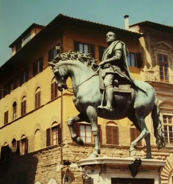Cosimo I Equestrian Monument, a bronze equestrian statue of a bearded man on a rearing horse, with people standing nearby.