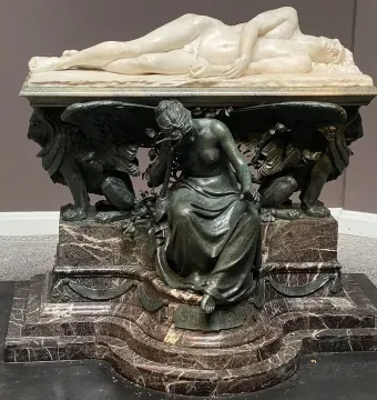 Shelley Memorial with a reclining white marble figure on a dark ornate base and seated draped mourner below.