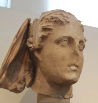 Marble head of Lycosoura Demeter with a weathered face and swept-back hair