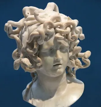 Bernini\'s Medusa, a marble bust with a downcast face and snakes carved as hair.