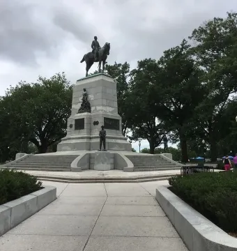 The Sherman Monument showing General William Tecumseh Sherman on horseback atop a tiered stone pedestal with bronze figures.
