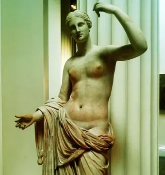 Townley Venus marble statue with one arm raised and the other extended, draped below the waist.