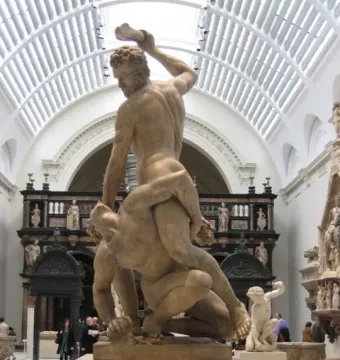 Samson Slaying a Philistine marble sculpture of two muscular men locked in a struggle in a museum hall