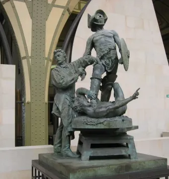 The Gladiators bronze sculpture group showing a helmeted combatant standing over a fallen opponent beside a standing figure.