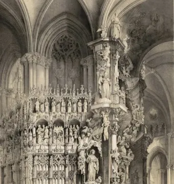 The Transparente altarpiece in Toledo Cathedral with sculpted saints and angels rising toward the vaulted ceiling as people gather below.