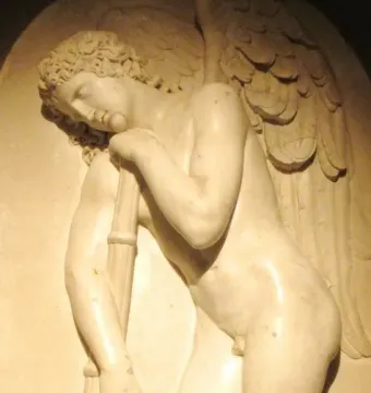 Marble bas-relief of a winged nude male figure leaning on an inverted torch with a rose garland.