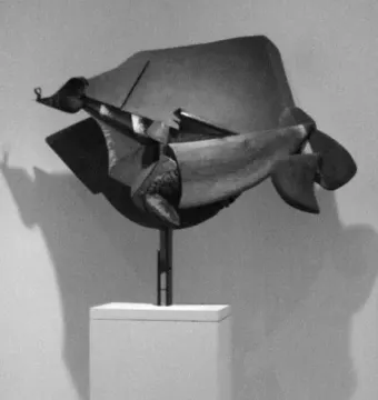 Abstract sculpture by Umberto Boccioni mounted on a pedestal, shown in black and white with a strong shadow on the wall.