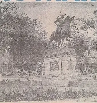 Francisco Pizarro equestrian statue on a stone pedestal in a park with trees and garden beds.