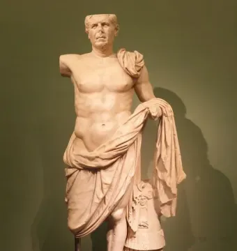 The General of Tivoli sculpture, a weathered stone figure with a missing head and right arm, draped across the body on a rectangular base.