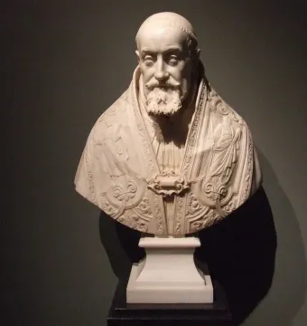 Marble bust of Pope Gregory XV with a carved robe and beard against a dark background.