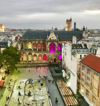 Stravinsky Fountain with colorful abstract sculptures in a rectangular basin in a city square.